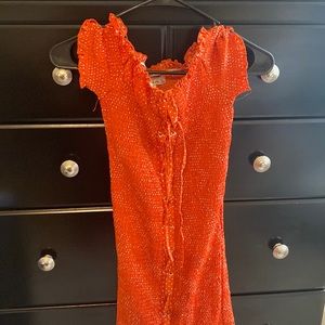 Very stretchy dress. It’s a reddish orange color. Purchased at a boutique